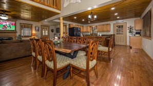 A spacious dining area with wooden furniture and a high ceiling. - Firepit - Mountain Views - Car Show Friendly (GATLINBURG)