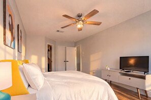 A bedroom with a bed, a ceiling fan, a television, and a dresser. - Private Hot Tub & Game Room near SeaWorld and Lackland AFB (San Antonio)