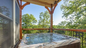 A hot tub on a wooden deck with a view of trees. - Pigeon Forge*Resort*Dogs Welcome*Sleeps 12*Dollywood (SEVIERVILLE)
