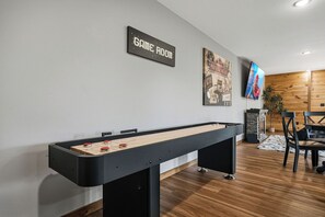 A pool table in a room with a 'GAME ROOM' sign, a movie night poster, and a television. - Level Up From Luxury & Incredible Mountain Views (SEVIERVILLE)