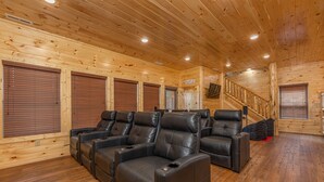 A wooden cabin interior with a wooden staircase, leather recliner seating, and a wooden floor. - Mountain Views And Games Galore (SEVIERVILLE)