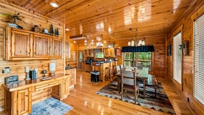 A wooden cabin interior with a kitchen, dining area, and bar. - Outdoor Fireplace And Gorgeous Mountain Views (SEVIERVILLE)