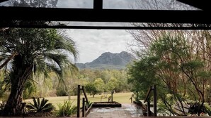 A view through a wooden structure with a mountain in the background.