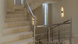 A modern staircase with metal railings and a handrail, leading to an upper floor. - Villa With Private Pool In Beverly Hills comp -Allegria residence-Sheikh Zayed (Giza Governorate)