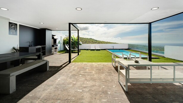 A modern kitchen with a view of a pool and a grassy area. - Holiday Villa 'Tulio Homme 2' with Sea Views, Private Pool and Wi-Fi (Adeje)