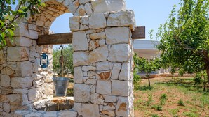 A stone structure with a wooden beam, a metal bucket, and a lantern. - Villa 'Perla Marina Luxury' with Sea View, Wi-Fi and Air Conditioning (TOTTE LAPILLO)