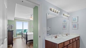 A modern bathroom with a large vanity, dual sinks, and a mirror with lights. - Breathtaking 16th-Floor Gulf Views • Sleeps 8 • Ariel Dunes II (Destin)