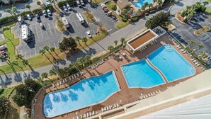 An aerial view of a hotel with two swimming pools, a parking lot, and surrounding greenery. - Breathtaking 16th-Floor Gulf Views • Sleeps 8 • Ariel Dunes II (Destin)