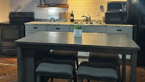 A modern kitchen with a central island, built-in appliances, and pendant lighting. - Downtown Studio loft in Rome.

 (Rome)