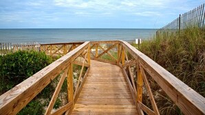 A wooden boardwalk leading to a beach with a wooden fence on one side. - Port of Call~2BR~Sleeps 10~Dogs ok~Steps to beach (Port St. Joe)