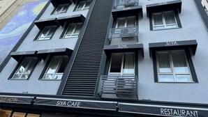 A building with multiple floors, each labeled with "SIYA" indicating a hotel or cafe. - Siya Boutique Hotel (Batman)