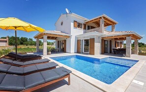A modern two-story house with a swimming pool, outdoor seating, and a satellite dish. - Beautiful home in Funtana (Funtana)