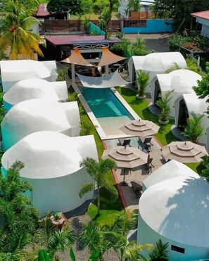 A resort with multiple dome-shaped buildings, a central swimming pool, and outdoor seating areas. - Alborada Boutique Stay  (Bahía Ballena)