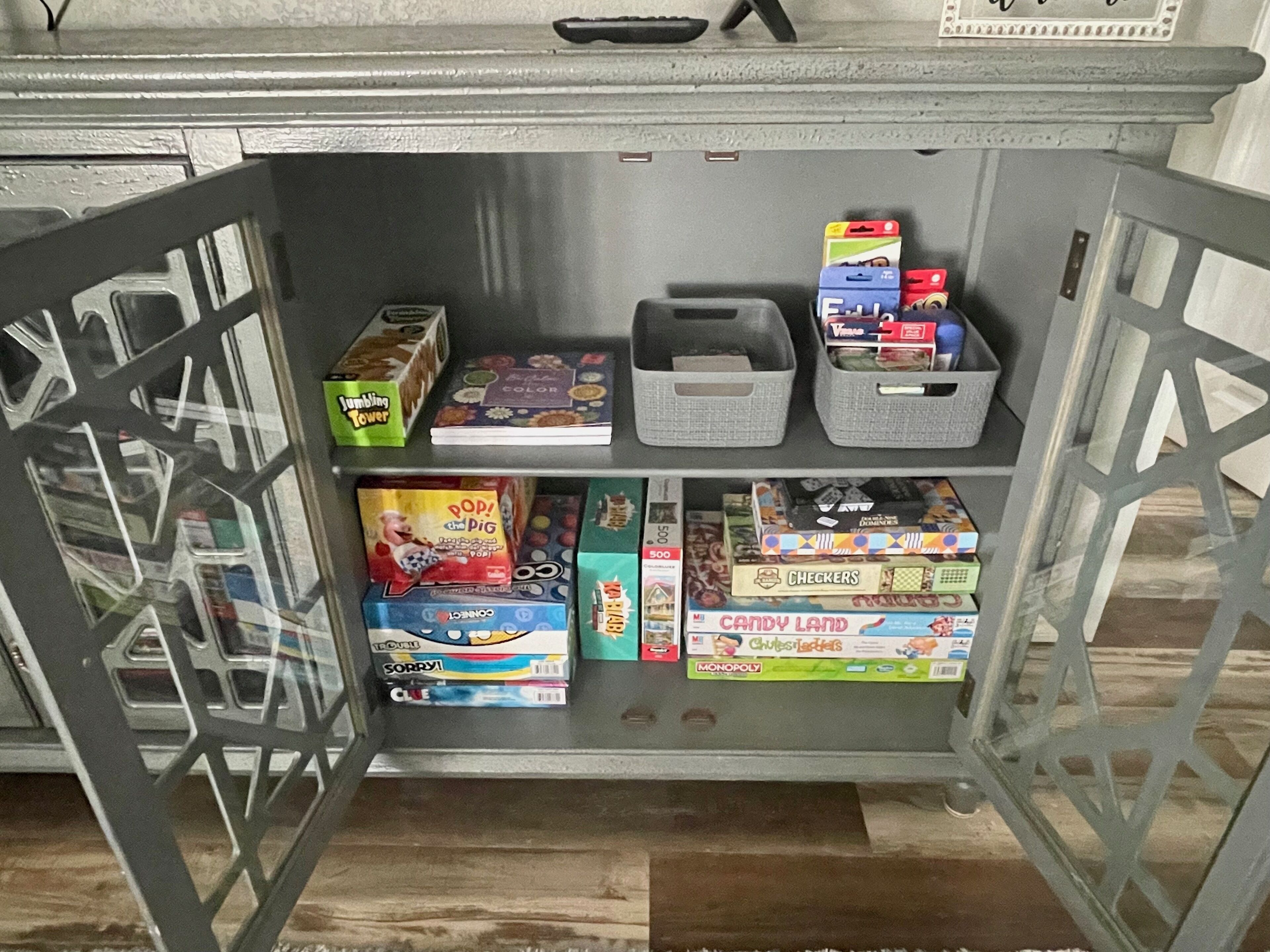 A shelf with various board games and puzzles.