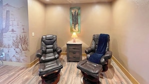 A massage room with two massage chairs, a small table with a lamp, and a painting on the wall. - Brand New House Right on Allen St one Block from the Birdcage
 (Tombstone)