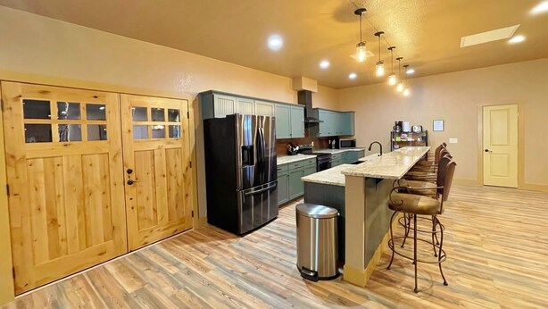 A spacious kitchen with wooden cabinets, a stainless steel refrigerator, and a marble countertop. - Brand New House Right on Allen St one Block from the Birdcage
 (Tombstone)
