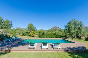 A swimming pool with lounge chairs, surrounded by greenery and hills. - YourHouse Son Jaumell 6, villa with pool in Cala Agulla (Capdepera)