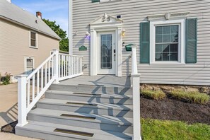 A two-story house with a front porch, a mailbox, and a well-maintained lawn. - Lakefront Retreat - Serene escape on Lake Erie! Amazing Views! Lorain OH (Lorain)