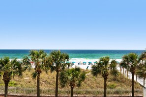 A beach with palm trees, a white fence, and the ocean. - Condo 2nd Floor 3br. 3ba with Private Beach in Destin (Destin)