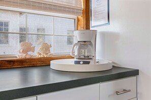 A coffee maker on a countertop near a window with a view of buildings. - Dry Dock - 1BR/1BA Seagrove Beach Cottage - Sleeps 4 - Near Beach Access (Seagrove Beach)