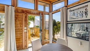 A room with large windows, a wooden ceiling, and a view of the outside. - Dry Dock: Your Cozy Beachside Retreat at 612 Eastern Lake Rd (Seagrove Beach)