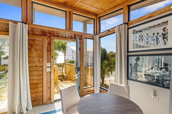 A room with large windows, a wooden ceiling, and a view of the outside. - Dry Dock - 1BR/1BA Seagrove Beach Cottage - Sleeps 4 - Near Beach Access (Seagrove Beach)