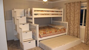 A bunk bed with drawers, a window with curtains, and a ceiling fan. - Welcome to BarnRoots a Cozy Family sized house, bring your friends (Florence)