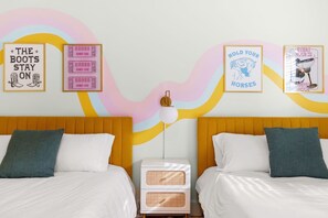 A bedroom with two beds, a nightstand, and wall art. - BACH! Heated Pool/Sleeps 10/Firepit/2miles DT, ACL (Austin)