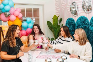 A group of people at a table with balloons and disco balls, suggesting a party or celebration. - BACH! Heated Pool/Sleeps 10/Firepit/2miles DT, ACL (Austin)