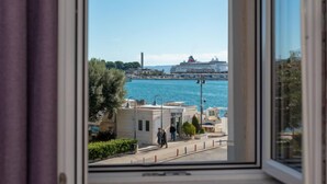 A view through a window of a coastal area with a cruise ship docked in the background. - Lara's House by Interhome (Split)