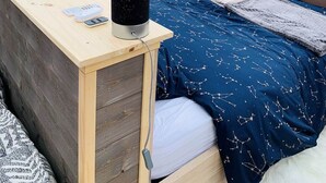 A cozy bedroom with a wooden desk, a bed with a star-patterned duvet, and a black speaker. - Starry Wigwam (pets not allowed) (MESSEY SUR GROSNE)