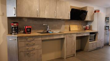 A modern kitchen with stainless steel appliances, a built-in oven, and a microwave.