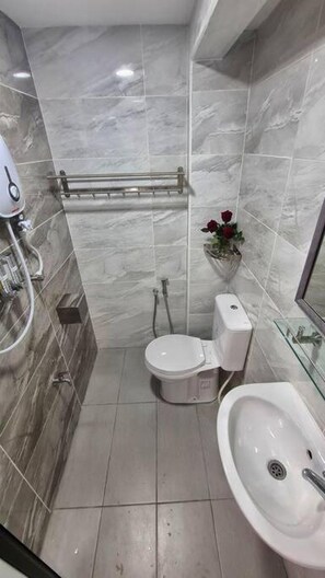 A small bathroom with a toilet, bidet, and sink. - Rusa Cottage (Sleeps 10 pax - 1 min walk from KSL) (Johor Bahru)