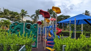 A playground with climbing structures, slides, and a covered area. - 2Bed/2Bath at the Tennis Village at Palmas del Mar (Humacao)