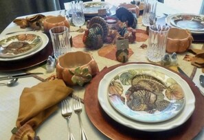 A table set with plates, glasses, and cutlery, suggesting a dining arrangement.