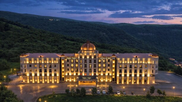 A large hotel with a central dome, multiple wings, and a well-lit facade. - Eighty Eight Hotel and Spa (Tsaghkadzor)