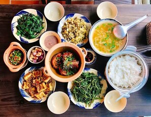 A variety of dishes including a bowl of soup, a plate of rice, and several side dishes. - Nghenh Xuan Farm - WellSpring Farm  (Chau Thanh)