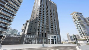 A high-rise building with a modern architectural design, featuring a prominent entrance and multiple balconies. - Silkhaus 15 Northside, Business Bay Dubai (Dubai)