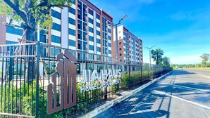 A modern hotel building with a sign reading "JIAHAUS HOTEL APARTMENT". - JIA HAUS Hotel Apartment (Buriram)
