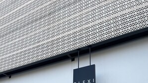 A building entrance with a large '39' sign, a 'PLEXI Athens Concept Rooms' sign, and two potted plants. - PlexiSpace (Athens)