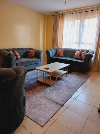 Exclusive Apartment | Living area | 24-inch Smart TV with digital channels. Lux Suites Greatwall Gardens Apartments