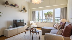 A modern living room with a television, sofa, and coffee table.