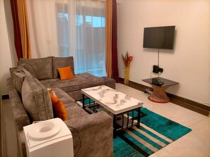 Deluxe Apartment | Living area | 24-inch Smart TV with satellite channels