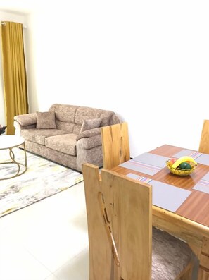 Elite Apartment | Living area | 24-inch Smart TV with satellite channels