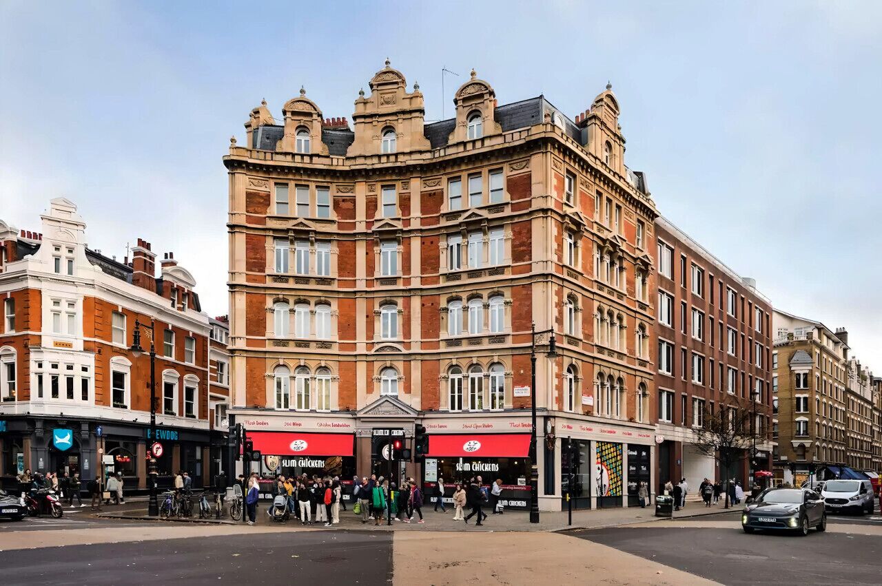 A historic building with multiple ground-floor shops, including a restaurant.