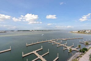 A marina with multiple docks, calm water, and a distant cityscape.