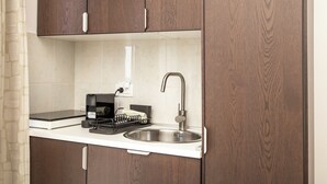 A kitchen with a built-in sink, a coffee machine, and a dish rack. - Kate`s place with balcony and amazing sea view for 3 persons (Dubrovnik)