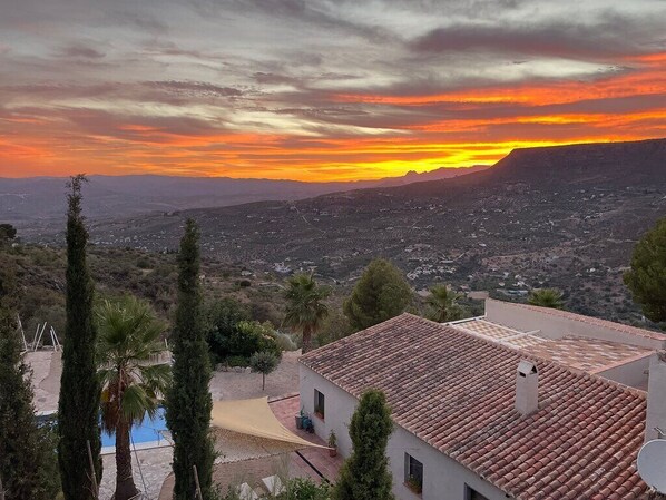 A residential area with a house featuring a tiled roof and a pool. - Boutique B&B El Refugio (Alcaucin)