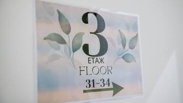 Une pancarte indiquant le numéro de la chambre 3, située à l’étage Etaz, avec une flèche pointant vers la droite.