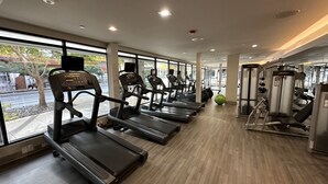 A gym with treadmills, exercise balls, and weight machines. - Luxury Living Steps from The Domain: Austin's Premier Shopping Haven! (Austin)